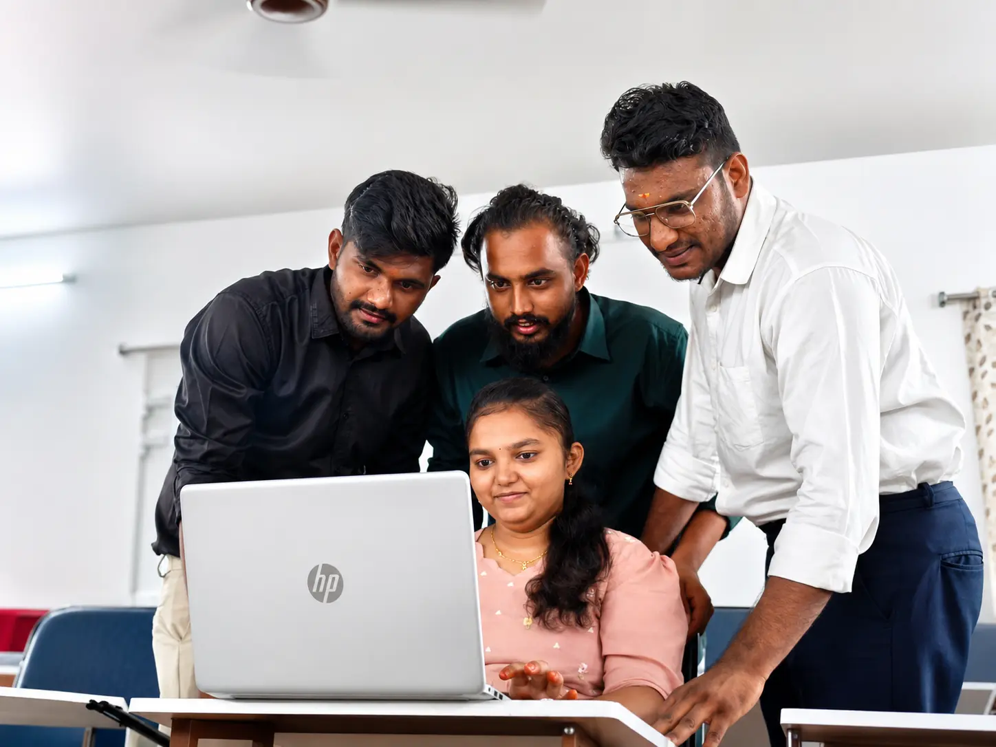 SSR Institute software trainees collaborating on a laptop in Vijayawada